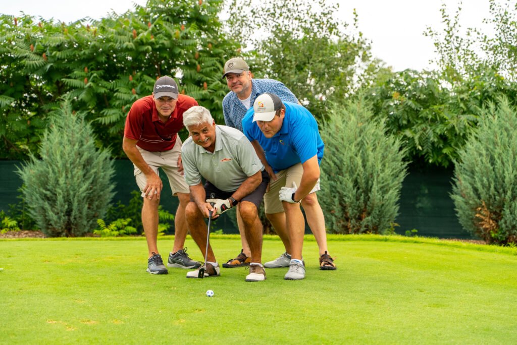 Participants enjoying a round of golf at the Make-A-Wish Wisconsin Golf Outing in Appleton, WI, captured in joyful moments.