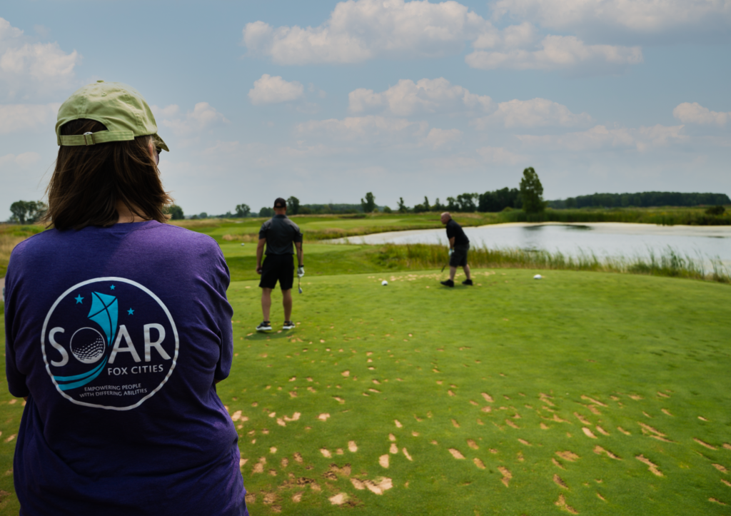 Golfers participating in the SOAR Fox Cities Golf Outing, an event dedicated to empowering people with differing abilities.
